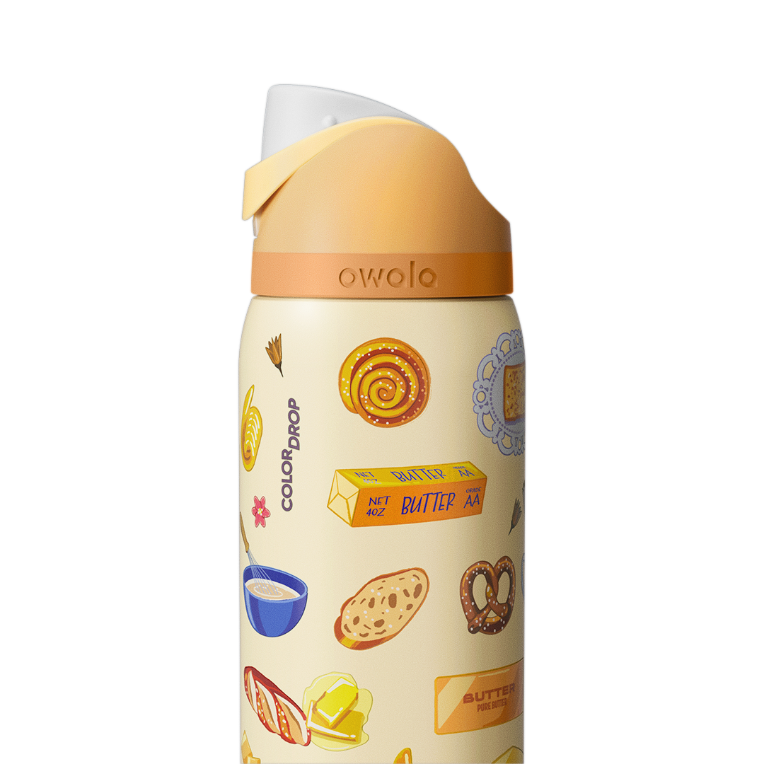 Owala FreeSip 32oz in Brunch Bunch, close-up of the cream patterned body with Color Drop wordmark and peach flip cap with cream carry loop
