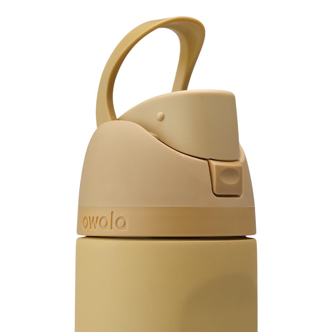 Owala FreeSip 24oz in Autumn Vista, close-up of warm honey-sand lid showing matching carry loop